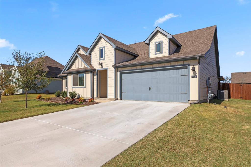 742 Buttercup Drive Pilot Point, TX 76258 - Photo 1 of 20 View of front of property featuring roof with shingles, concrete driveway, board and batten siding, and an attached garage