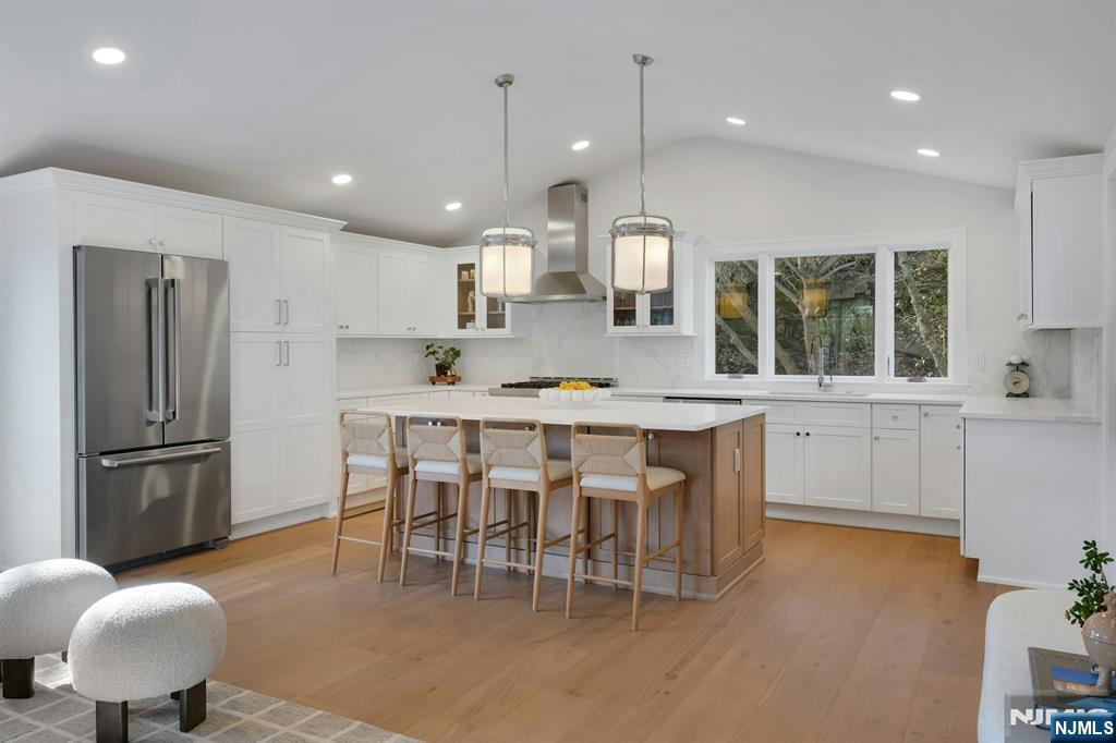 30 Edgecliff Road Montclair, NJ 07043 - Photo 14 of 46 a kitchen with stainless steel appliances kitchen island granite countertop a table chairs sink and cabinets