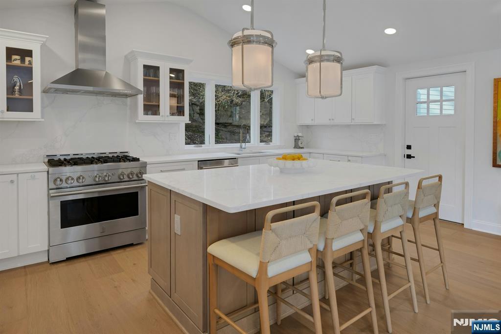 30 Edgecliff Road Montclair, NJ 07043 - Photo 16 of 46 a kitchen with a stove a table and chairs in it
