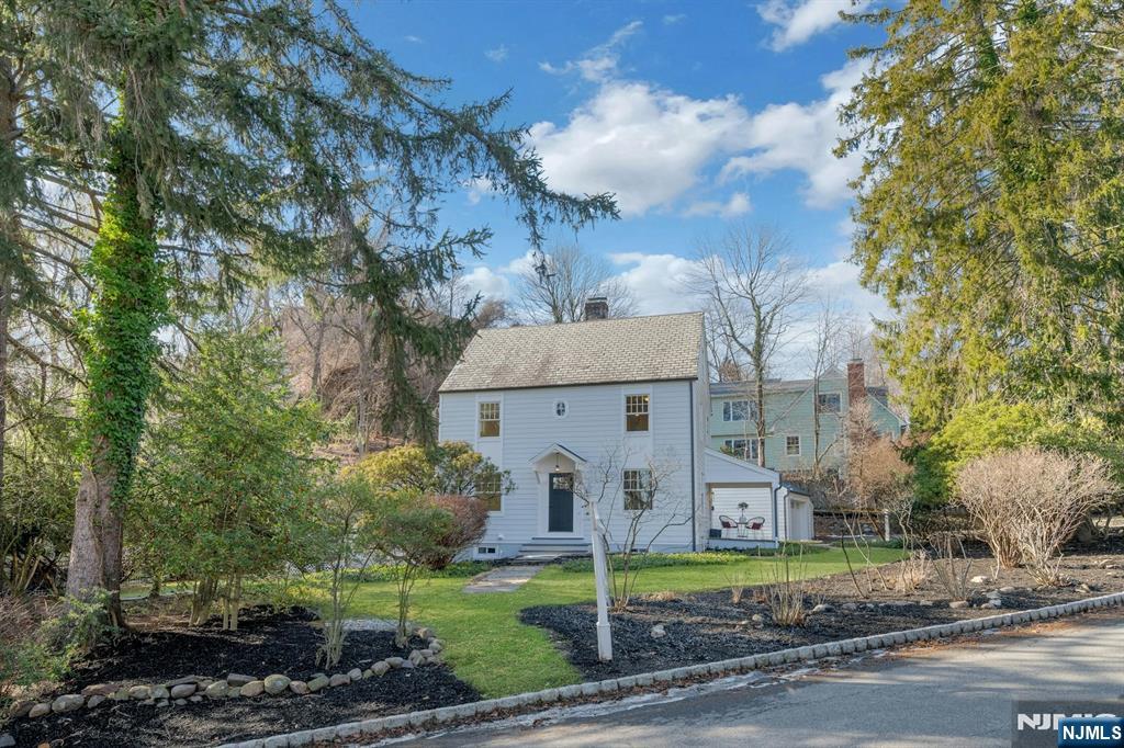 30 Edgecliff Road Montclair, NJ 07043 - Photo 2 of 46 a view of a white house next to a yard with big trees
