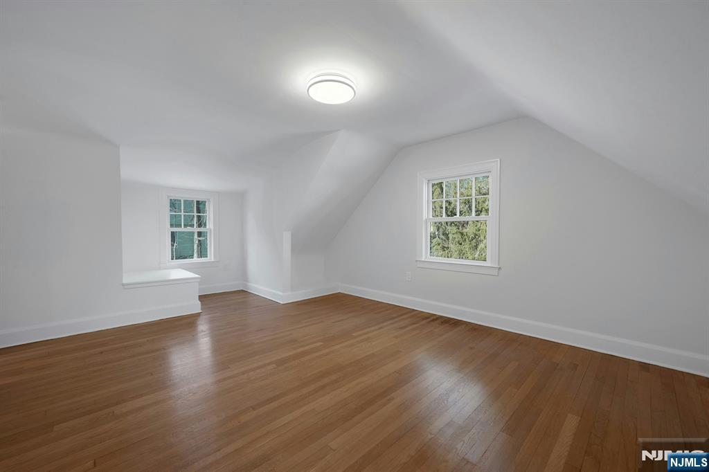 30 Edgecliff Road Montclair, NJ 07043 - Photo 30 of 46 an empty room with wooden floor and windows
