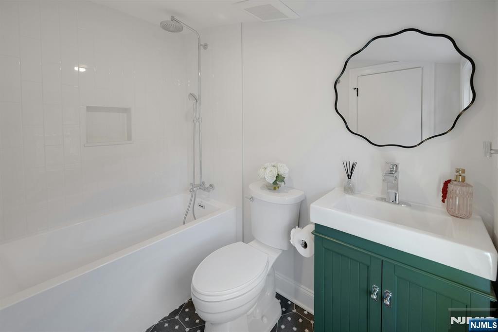 30 Edgecliff Road Montclair, NJ 07043 - Photo 31 of 46 a bathroom with a sink a toilet and a mirror