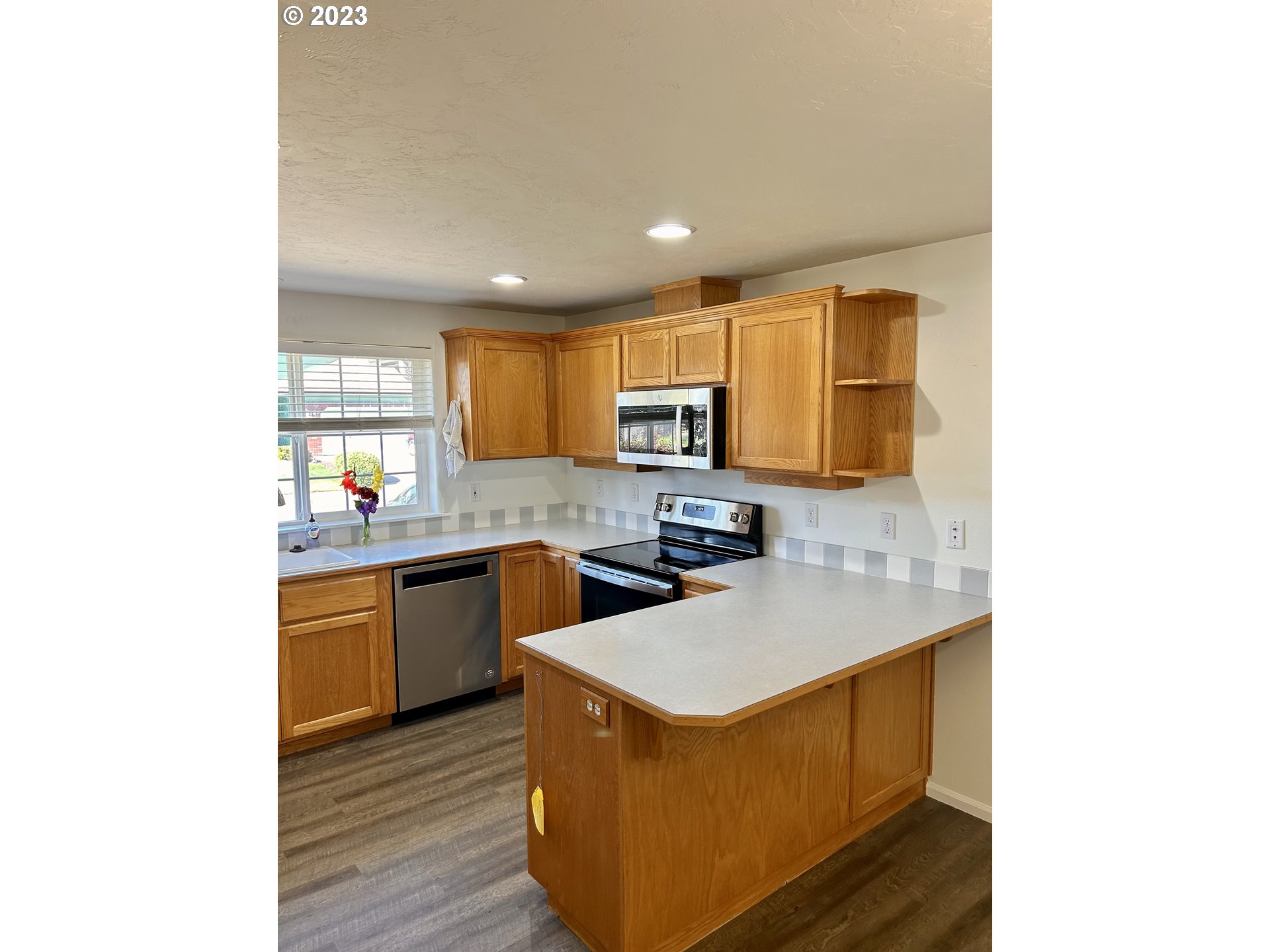 3883 Pinyon Street Springfield, OR 97478 - Photo 17 of 36 a kitchen with stainless steel appliances granite countertop a sink stove and refrigerator