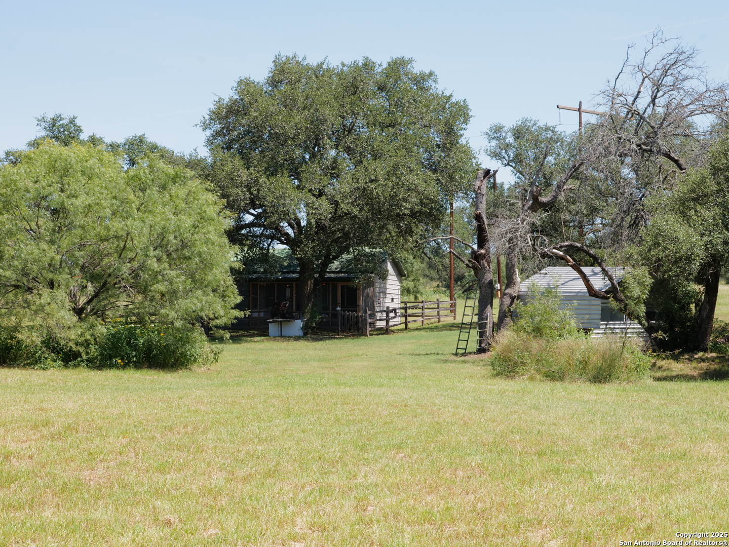 7200 South Us Highw Mason, TX 76856 - Photo 15 of 41 a yellow house in middle of the middle of a yard