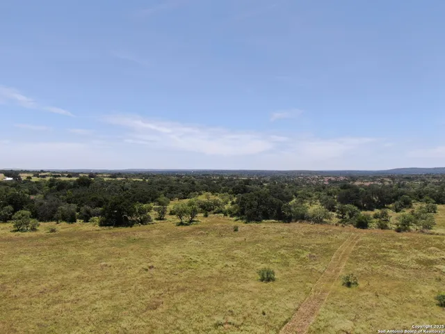 a view of a field with an ocean