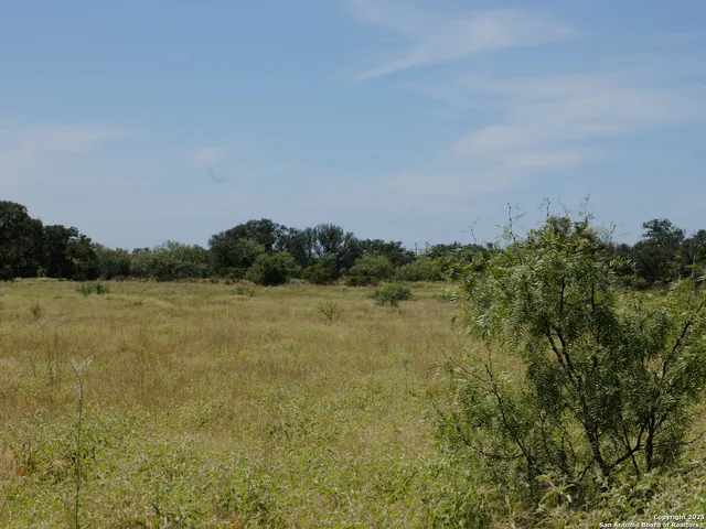 a row of lawn chairs under an umbrella