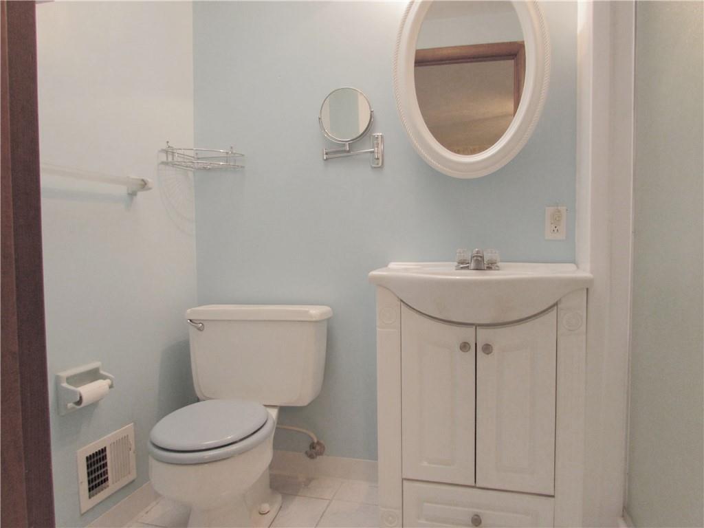 717 Blue Ridge Road Pittsburgh, PA 15239 - Photo 15 of 25 a bathroom with a sink a toilet and a mirror