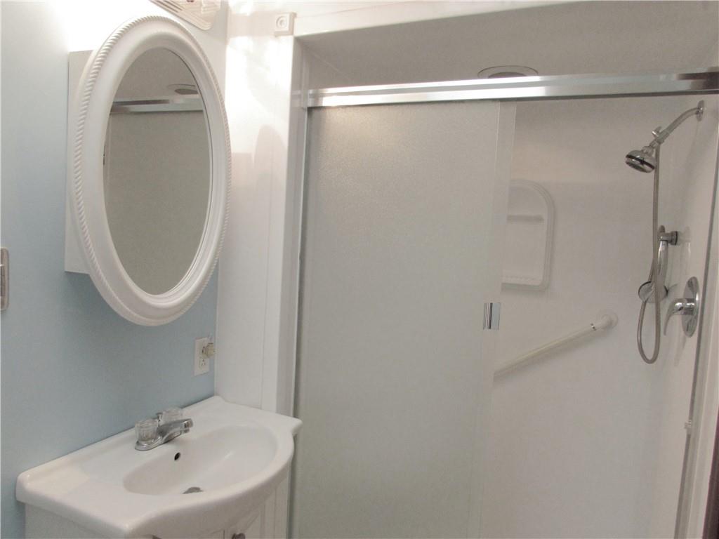 717 Blue Ridge Road Pittsburgh, PA 15239 - Photo 16 of 25 a bathroom with a sink a toilet and a mirror