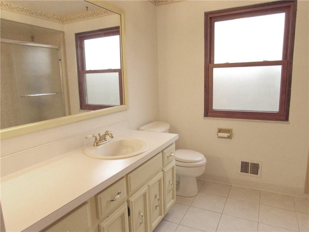 717 Blue Ridge Road Pittsburgh, PA 15239 - Photo 18 of 25 a bathroom with a toilet sink and mirror