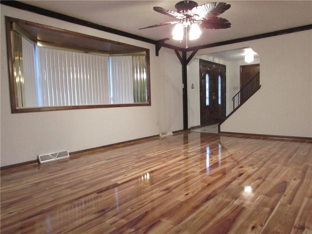 717 Blue Ridge Road Pittsburgh, PA 15239 - Photo 5 of 25 a view of an empty room with wooden floor and a window