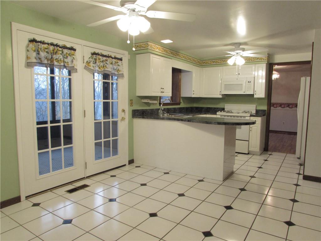 717 Blue Ridge Road Pittsburgh, PA 15239 - Photo 8 of 25 a kitchen with stainless steel appliances granite countertop a stove a sink and a refrigerator
