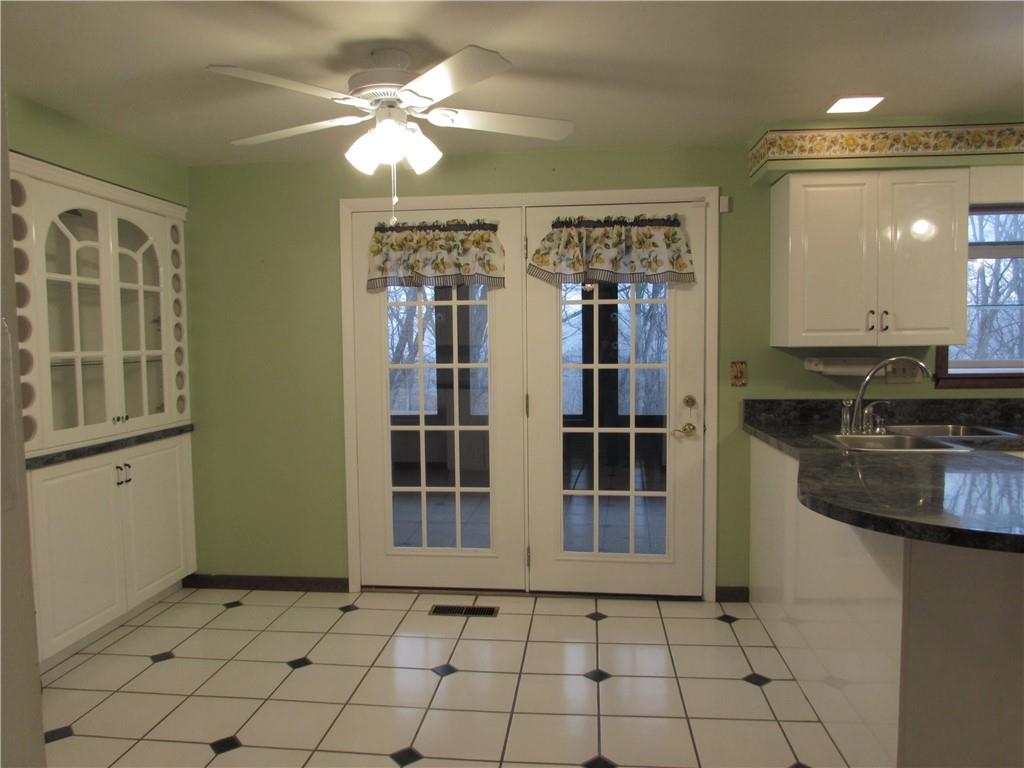 717 Blue Ridge Road Pittsburgh, PA 15239 - Photo 9 of 25 a view of a livingroom with a chandelier fan and kitchen view