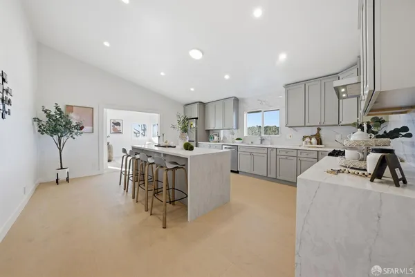 a kitchen that has a lot of cabinets in it and appliances