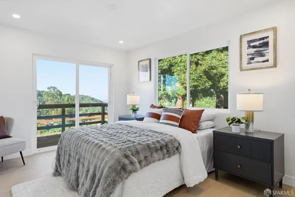 a bedroom with a bed and a large window