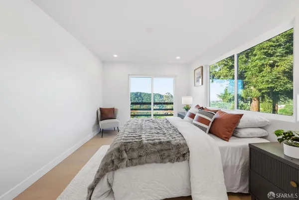a bedroom with a large bed and a large window