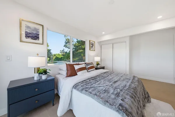 a bed room with a bed and a potted plant