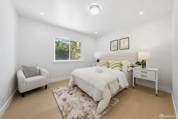 a bedroom with bed and a couch