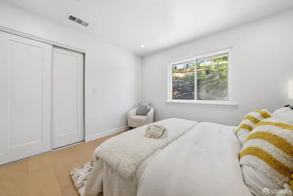 a bedroom with a bed and a window