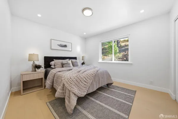 a bedroom with a bed and a night stand