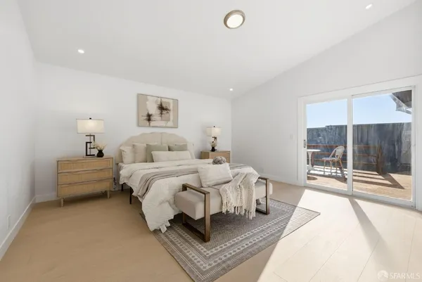 a spacious bedroom with a bed and glass door