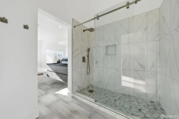 a spacious bathroom with a granite countertop tub a sink and a large mirror