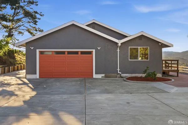 a view of a house with a yard and garage