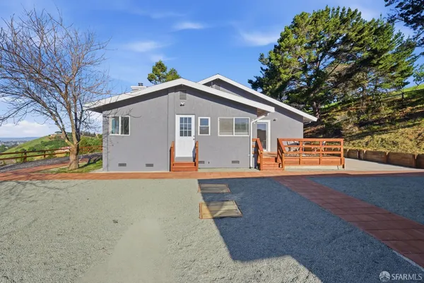 a view of house with outdoor space and parking