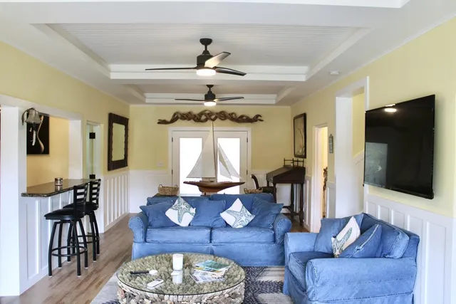 a white bed sitting in a bedroom next to a window