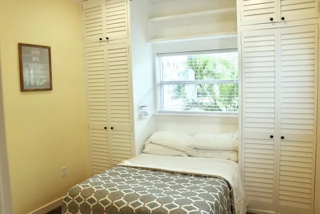 a view of a room with wooden floor and windows