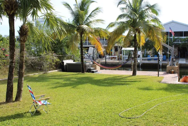 a kitchen with stainless steel appliances granite countertop a refrigerator a stove a sink and a microwave