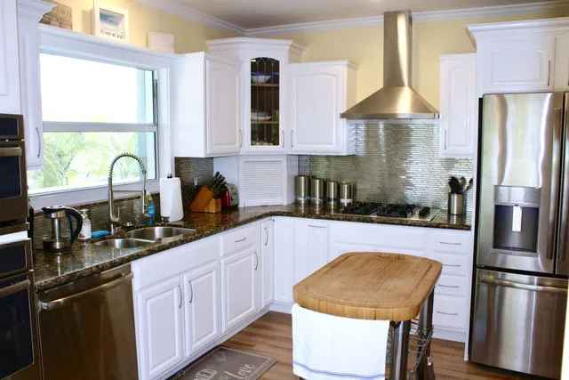 a kitchen with a stove and a window