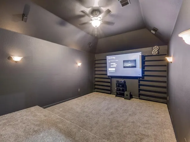 a view of a room with a projector and fan
