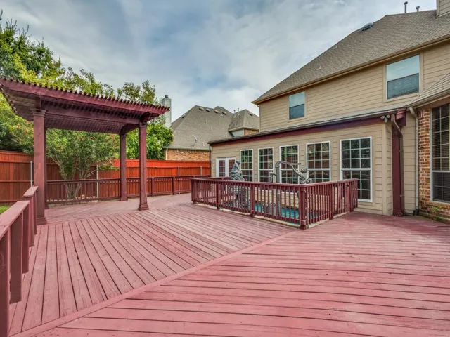 a view of a house with wooden floor in front of house