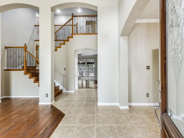 a view of a hallway with wooden floor and entryway