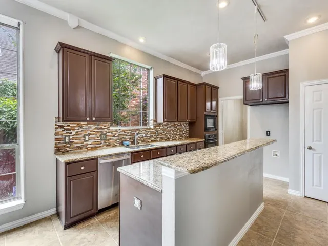 a kitchen with stainless steel appliances granite countertop a stove and a sink