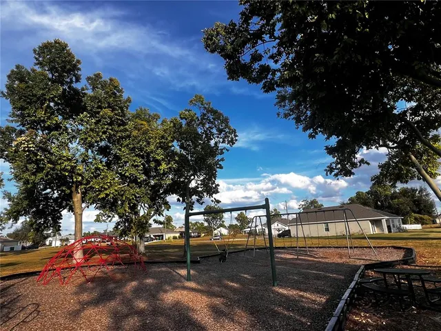 a view of a room with lots of swings and slides