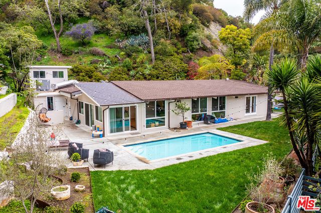 a front view of a house with a yard table and chairs