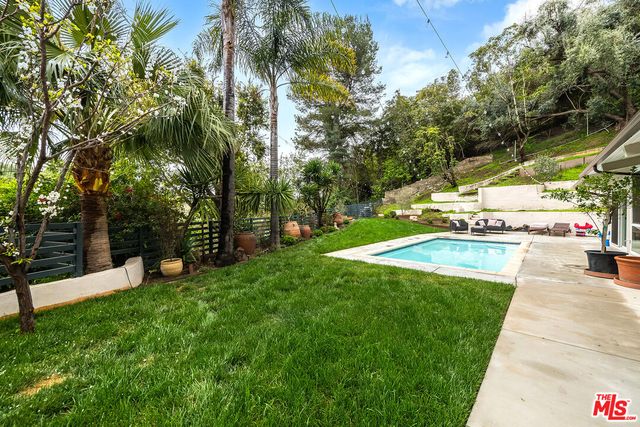 a view of a backyard with swimming pool