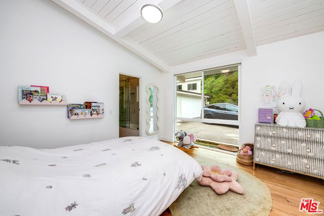 a bedroom with a bed and a large window