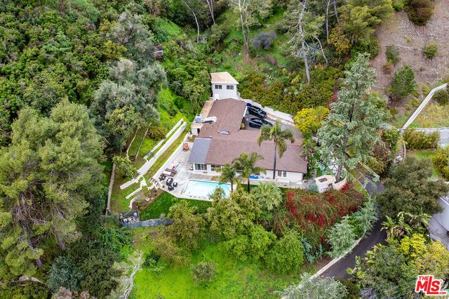an aerial view of a house with yard swimming pool and outdoor seating