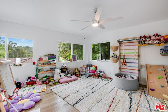a playing room with toys and a wooden floor