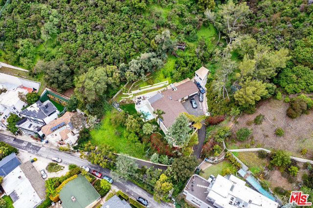 an aerial view of a house with a yard