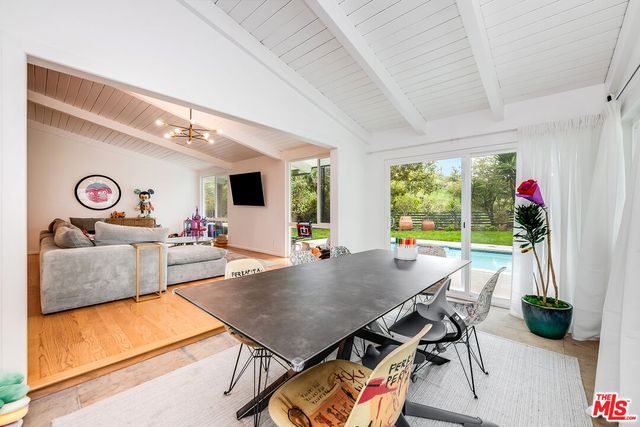a living room with furniture and floor to ceiling window