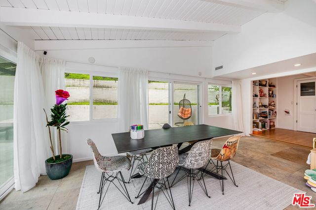 a view of a dining room with furniture and a potted plant