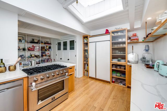 a kitchen with stainless steel appliances a stove and a refrigerator
