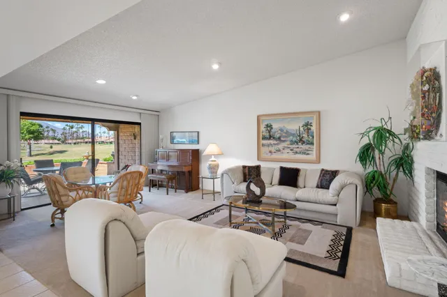 a living room with furniture large window and flat screen tv