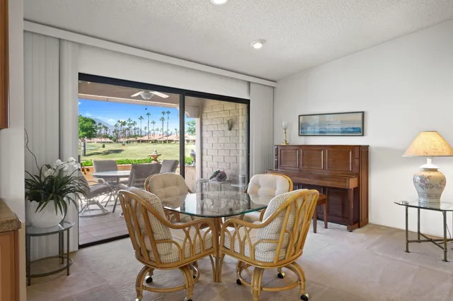a dining room with furniture window and outside view
