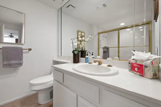 a bathroom with a sink toilet and mirror