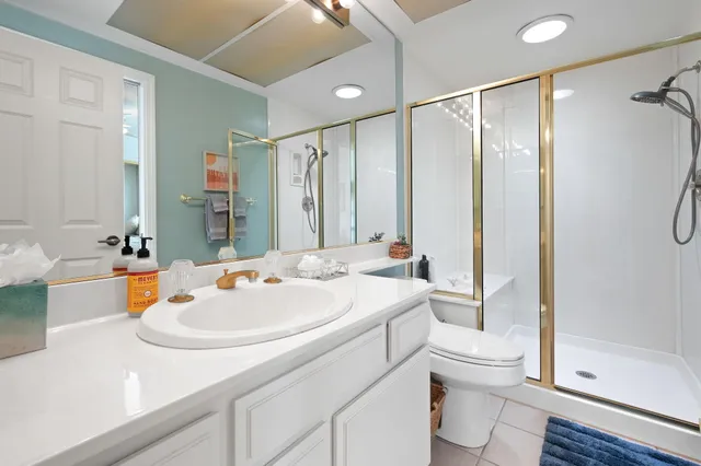 a bathroom with a sink a toilet and shower