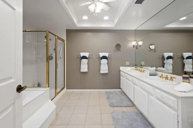 a bathroom with a double vanity sink a mirror and shower